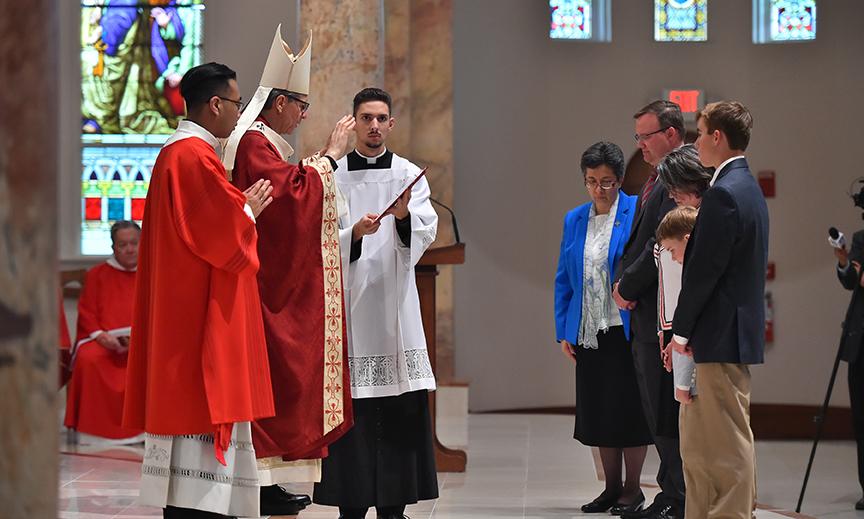 Archbishop Gustavo blesses Dr. Evans and his family