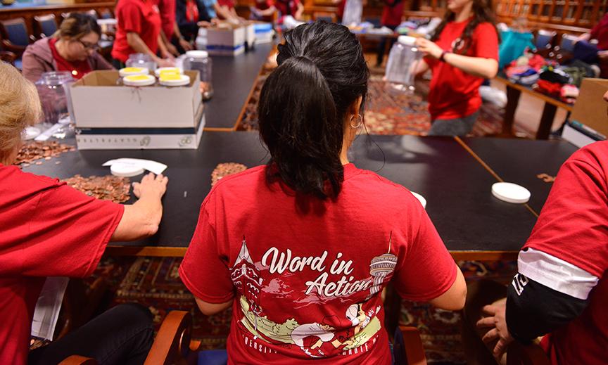 Volunteers sort pennies