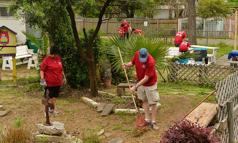 Volunteers work on a yard