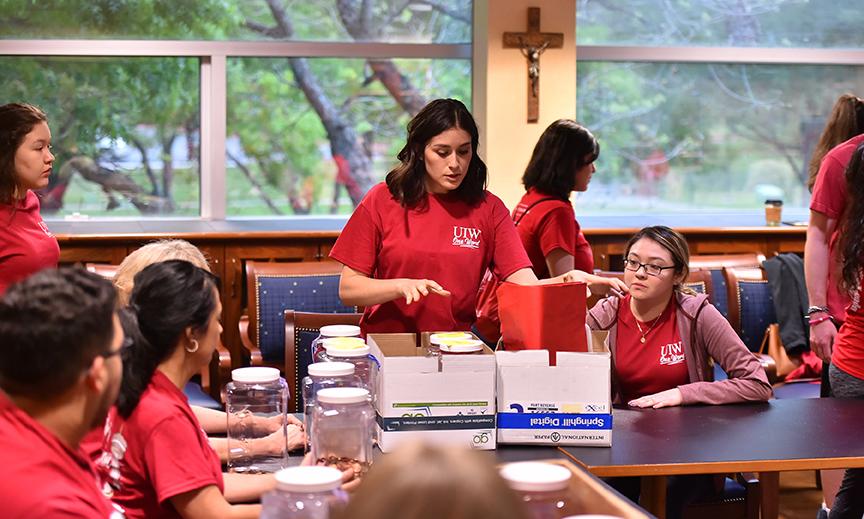 Volunteers sort empty glass jars