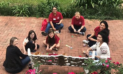 Volunteers with chalk at a park bench