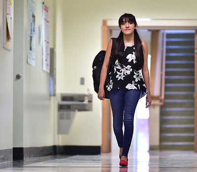 Ixtaccihuatl Obregon walking down an university hallway