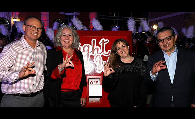 UIW leadership in front of the Light the Way switch 