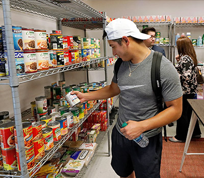 UIW student visiting the Cardinal Cupboard pantry