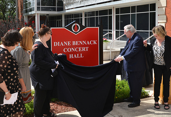 Family unveiling concert hall sign