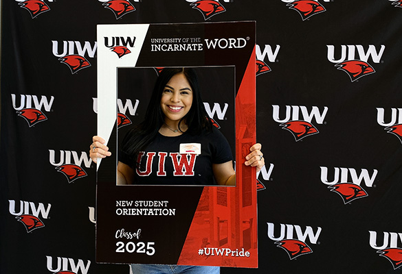 Student holding UIW sign