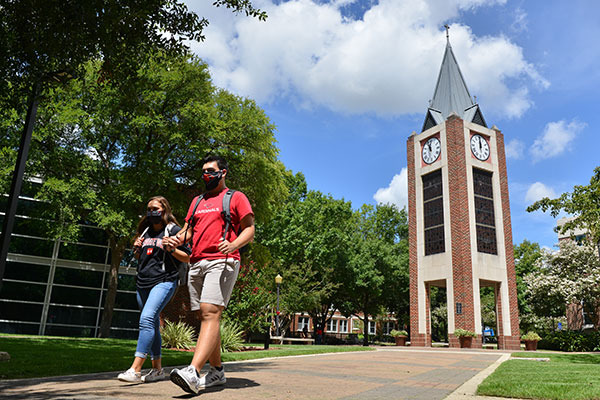 students walking in front of UIW clocktower