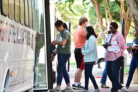 student walking into bus
