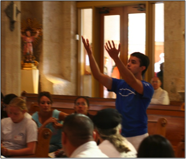 Gabriel Zertuche dances “Pues Si Vivimos” at San Fernando as Archbishop Flores looks on.