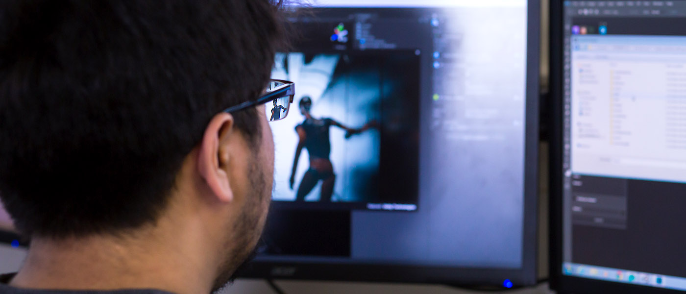 close up of a student at his computer working on a 3D animation project