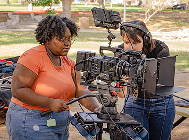 student operating a film camera