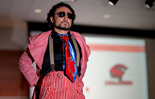 Student posing in a pant suit at the fashion form function show