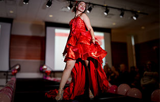 Student posing in a dress for fashion form function show