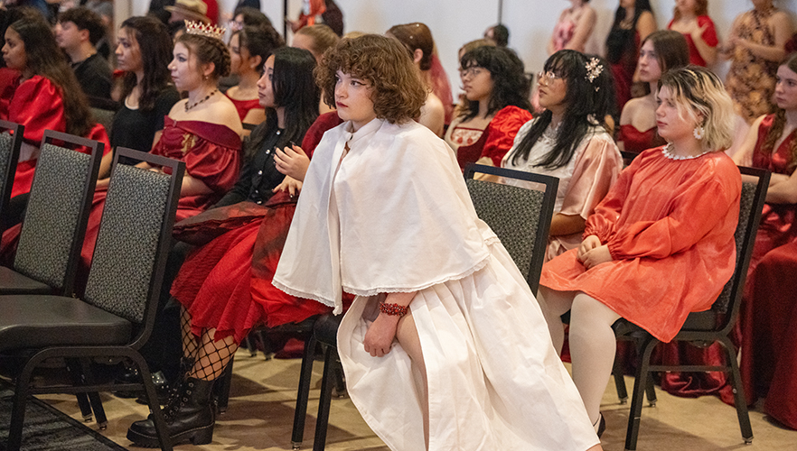 Models seated in audience at Red Dress Fashion Show