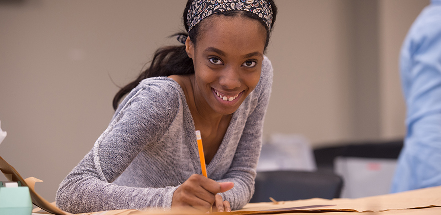 Smiling student sketching