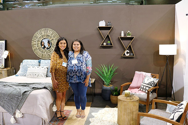 Students standing amid their interior design showcase during the Home and Garden show