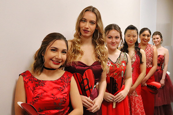 Fashion models standing in line at the Red Dress Fashion Show
