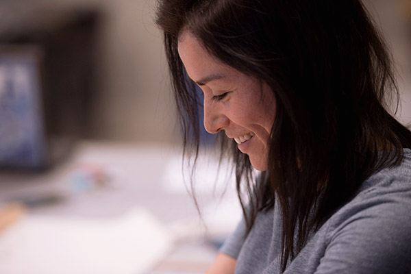 Close up of a female fashion student working on her project in class