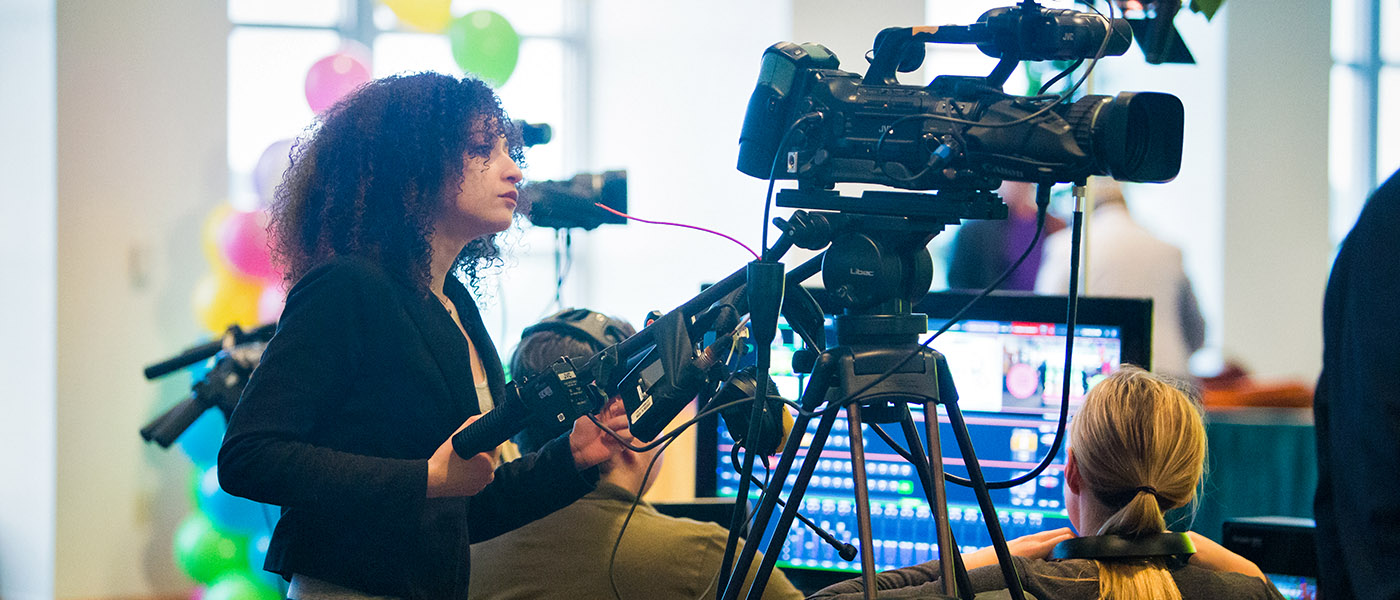 Student operating a TV camera during a broadcast production