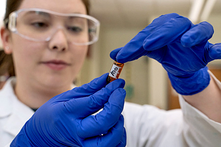 chemistry student with sample