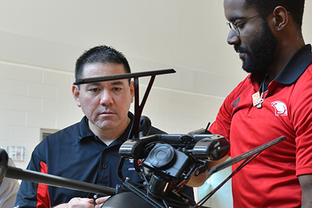 Engineering student and faculty holding a drone