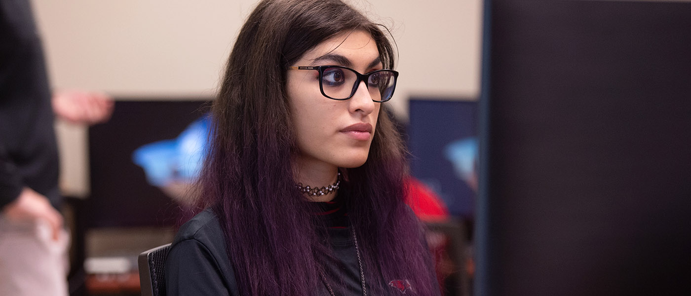Close up of CIS student at her computer workstation during class
