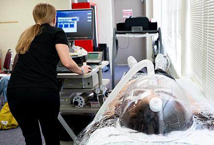 Instructor performing metabolic analysis on student