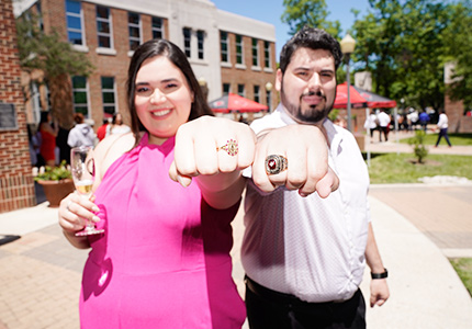 two students showing their ring